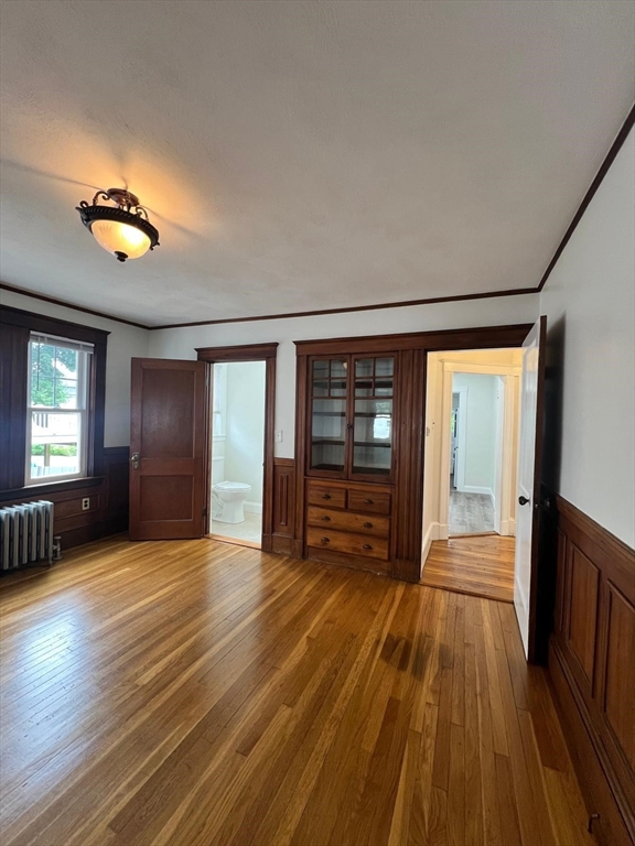 96 Brooks Street, Unit 1 Boston, MA 02135 - Photo 10 of 19 wooden floor in an empty room with a window