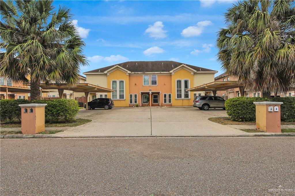 3700 South Embassy Avenue, Unit 1 Pharr, TX 78577 - Photo 1 of 12 a view of a house with a yard and palm trees