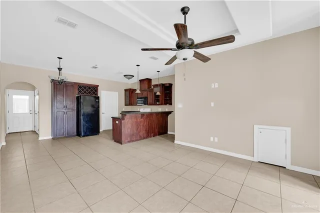 a view of a kitchen with a sink and a refrigerator