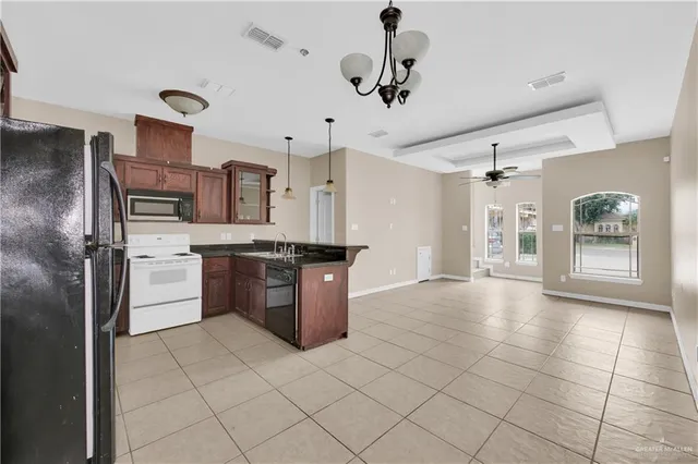 a large kitchen with cabinets and stainless steel appliances