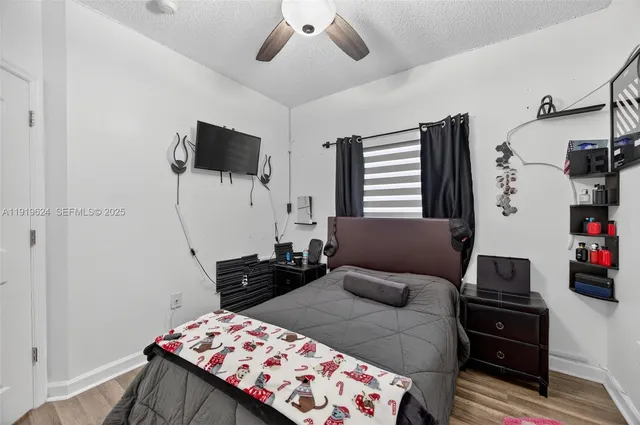 a bedroom with a bed and flat screen tv