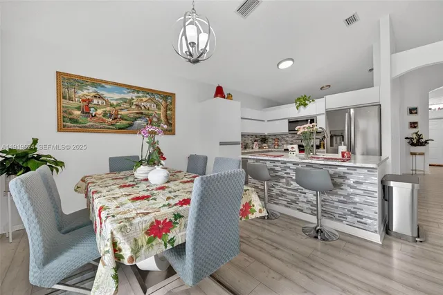 a dining room with furniture a rug and wooden floor