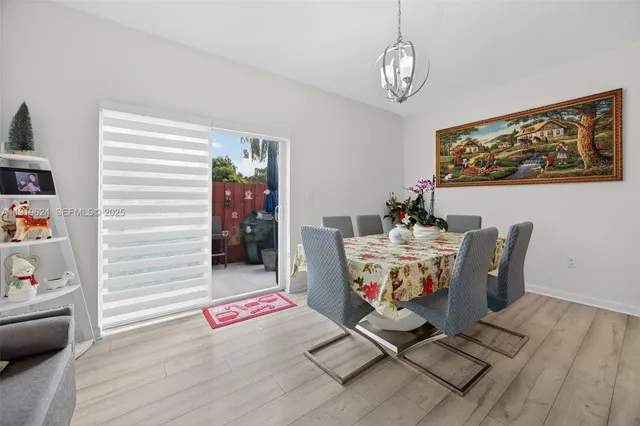 a dining room with furniture and wooden floor