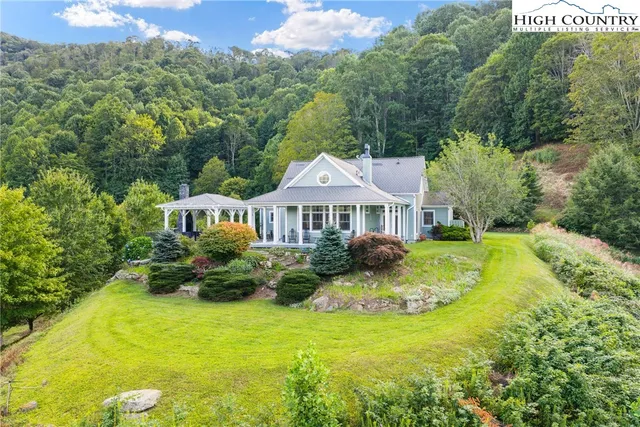 a front view of a house with yard and green space