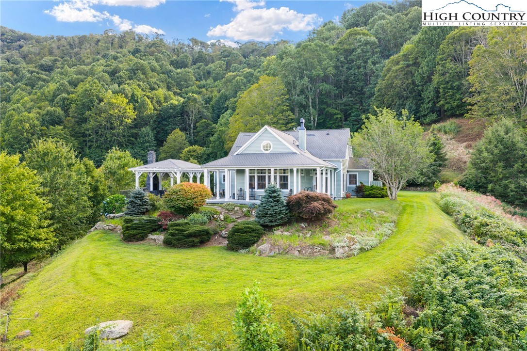 a front view of a house with yard and green space