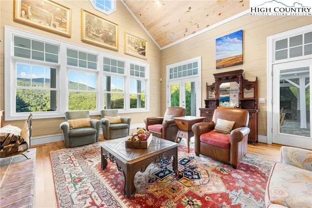 a living room with furniture fireplace and a large window