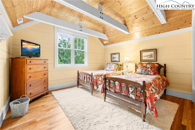 a bed room with a bed and a television