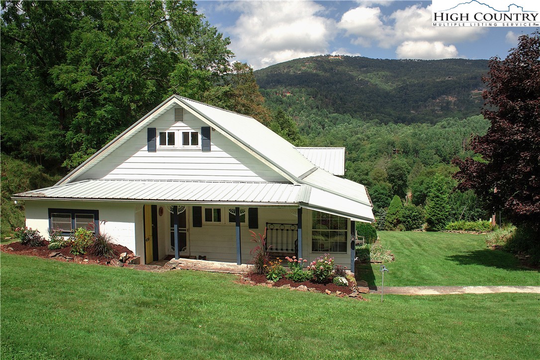 410-560 Puckett Road Banner Elk, NC 28604 - Photo 29 of 50 a front view of a house with a garden and porch