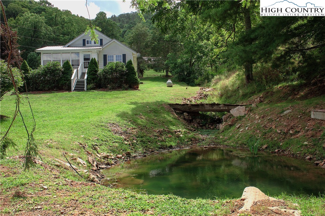 410-560 Puckett Road Banner Elk, NC 28604 - Photo 33 of 50 a view of a house with a yard and a fountain