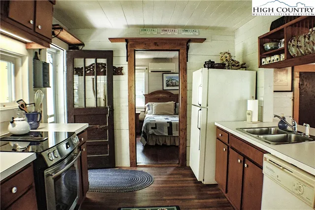 a kitchen with sink refrigerator and stove