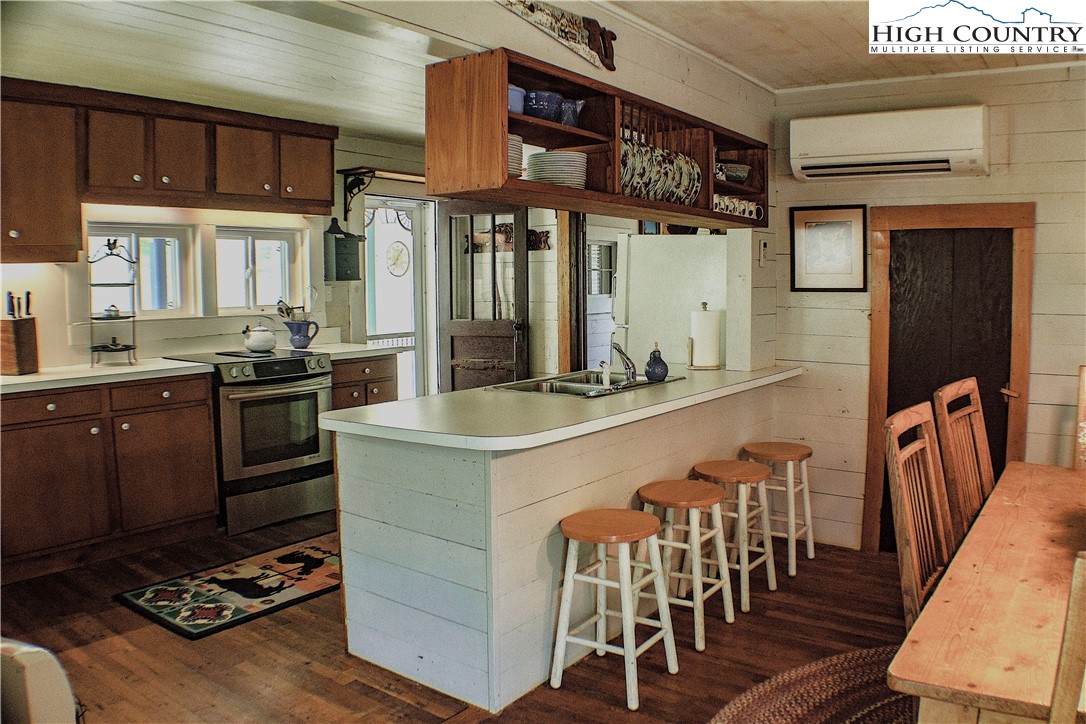 410-560 Puckett Road Banner Elk, NC 28604 - Photo 35 of 50 a kitchen with stainless steel appliances granite countertop a stove and a refrigerator