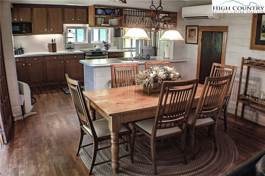 410-560 Puckett Road Banner Elk, NC 28604 - Photo 36 of 50 a dining room with furniture a rug and wooden floor