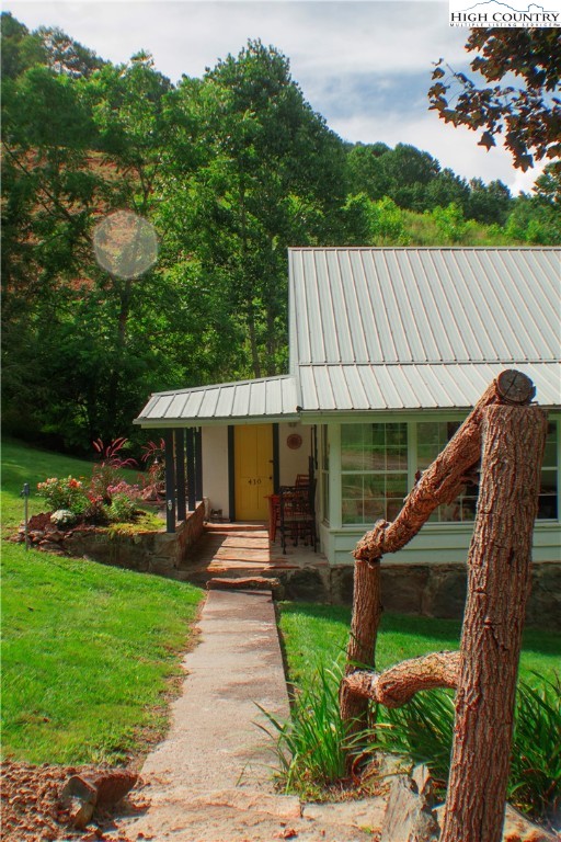 410-560 Puckett Road Banner Elk, NC 28604 - Photo 50 of 50 a front view of a house with garden