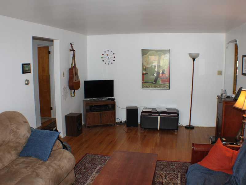 1010 Connor Road Mt. Lebanon, PA 15234 - Photo 4 of 24 Living Room. There are exposed hardwood floors in the living room and throughout the house. There is ample wall space for pictures and other artwork.