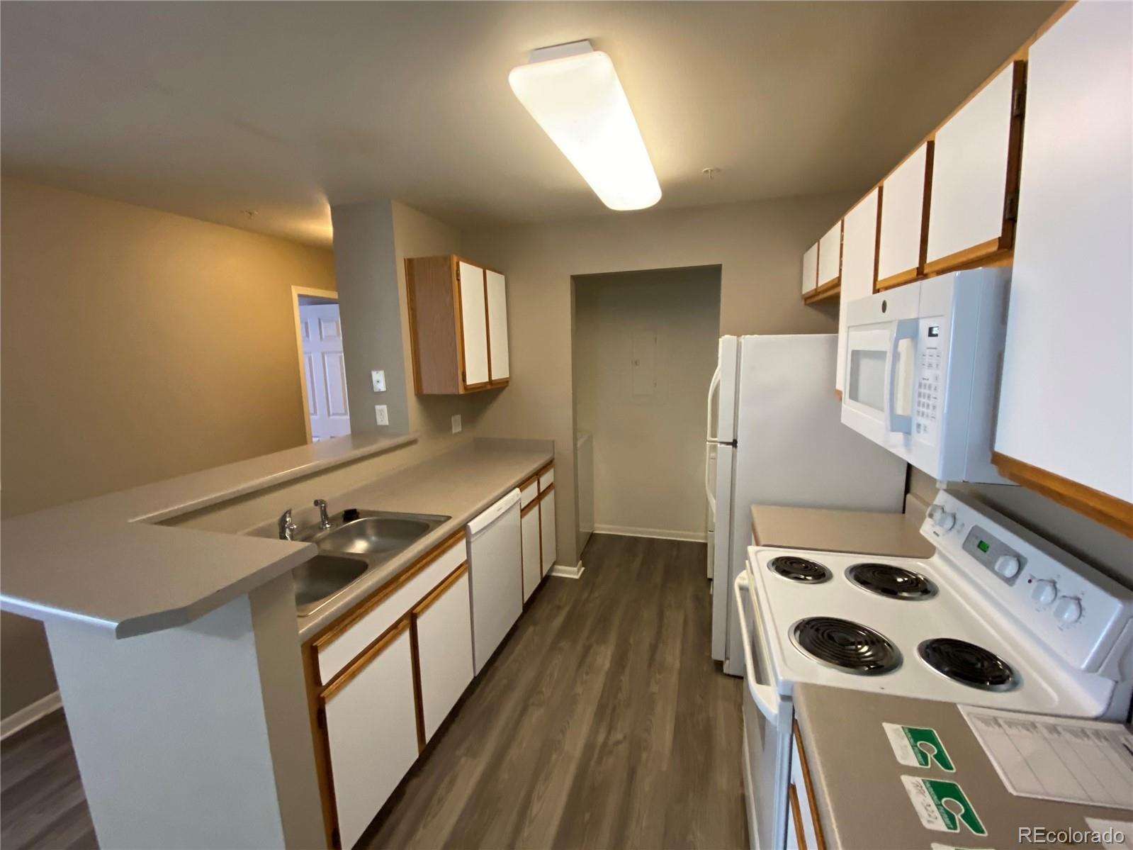 2226 West Elizabeth Street, Unit 202 Fort Collins, CO 80521 - Photo 5 of 9 a kitchen with stainless steel appliances a stove a sink and a refrigerator