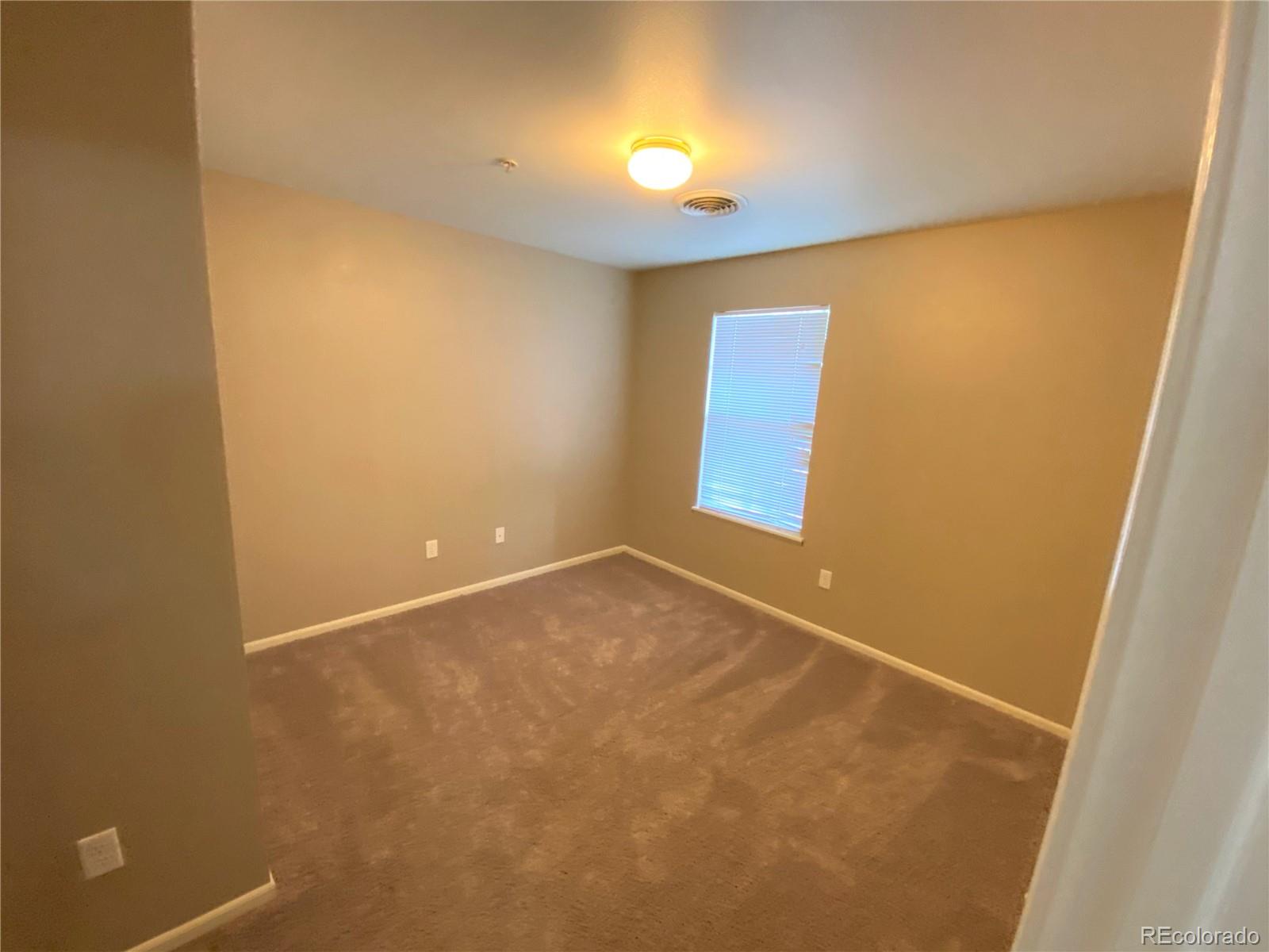 2226 West Elizabeth Street, Unit 202 Fort Collins, CO 80521 - Photo 6 of 9 an empty room with a window