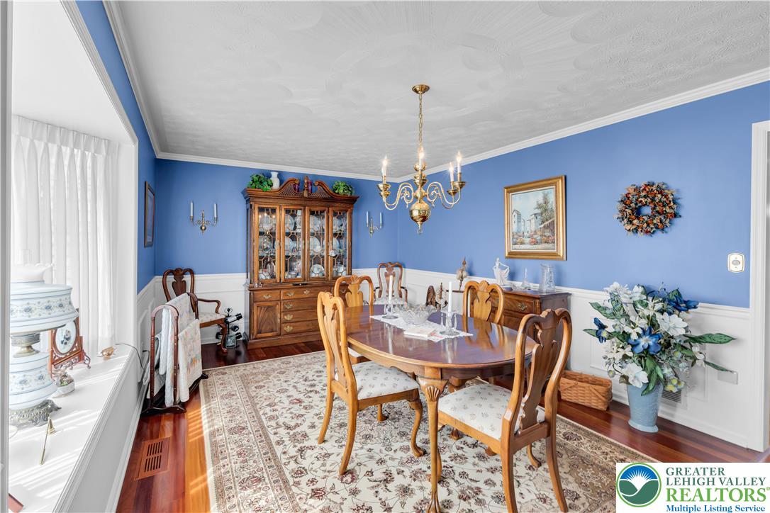 4059 Old Sentry Road Allentown, PA 18104 - Photo 6 of 39 A well-appointed dining space offers rich hardwood floors and an elegant chandelier for memorable meals.