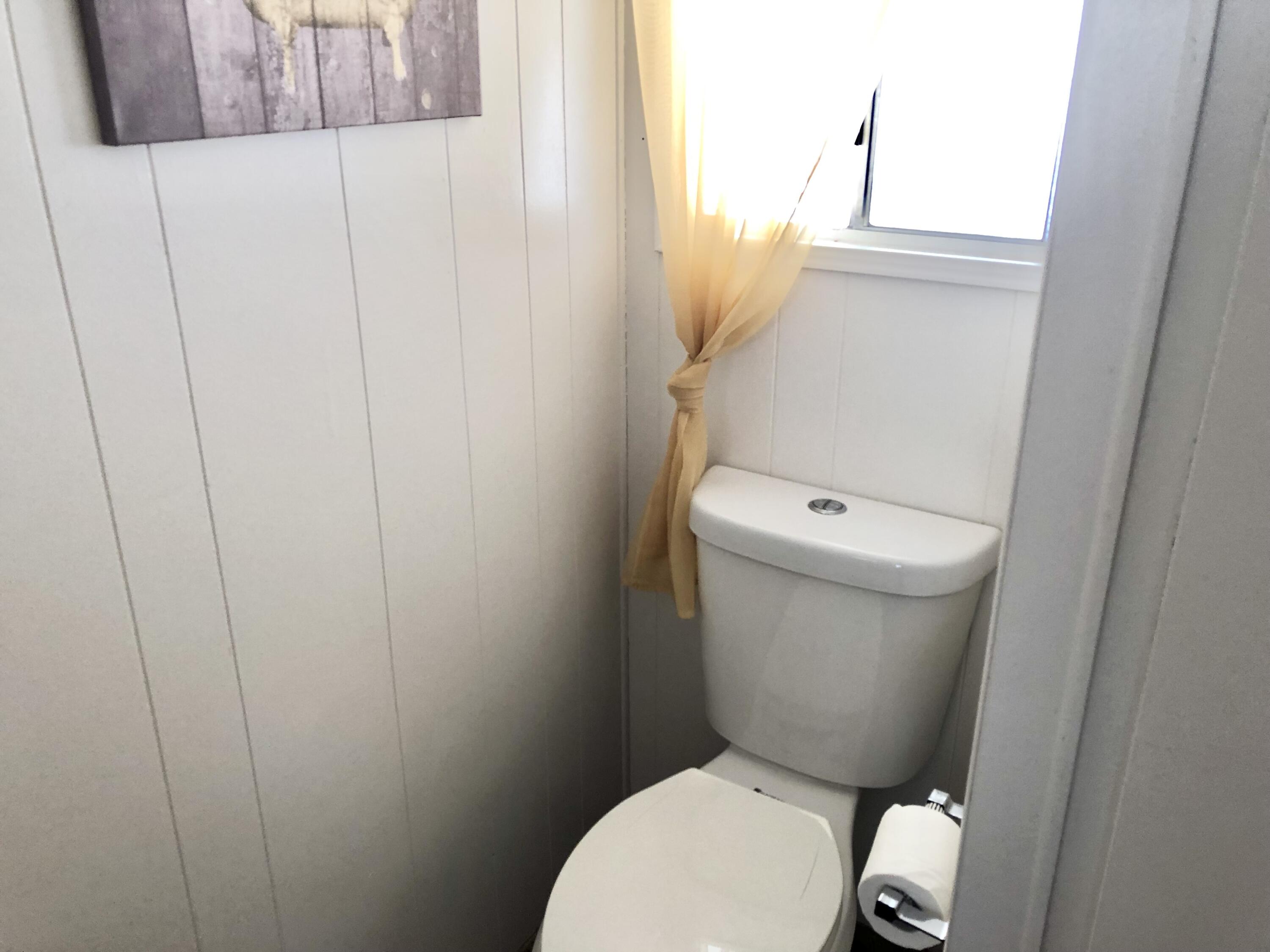 74711 Dillon Road Desert Hot Springs, CA 92241 - Photo 15 of 69 a white toilet sitting next to a white cabinet