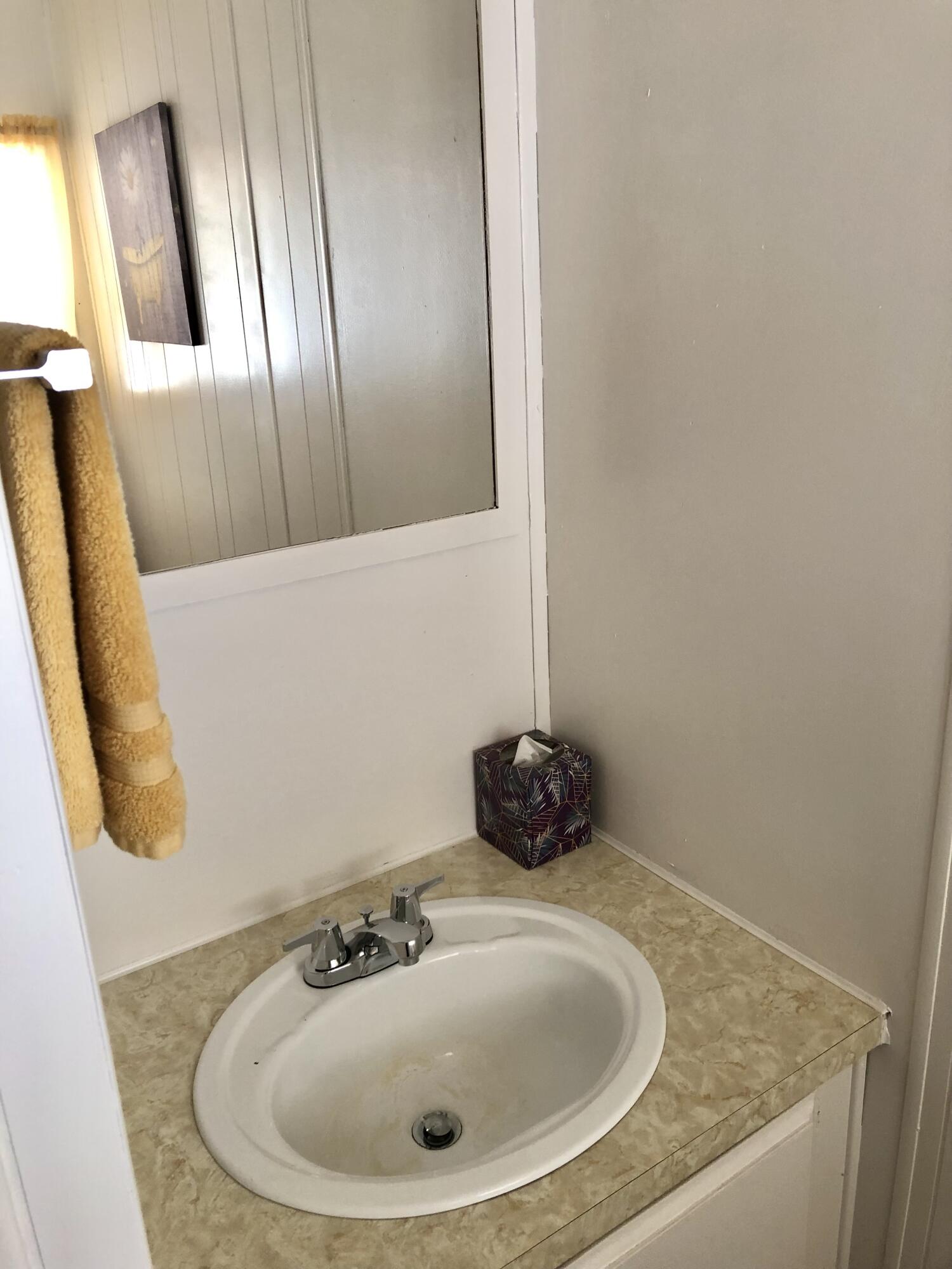 74711 Dillon Road Desert Hot Springs, CA 92241 - Photo 16 of 69 a bathroom with a sink and mirror