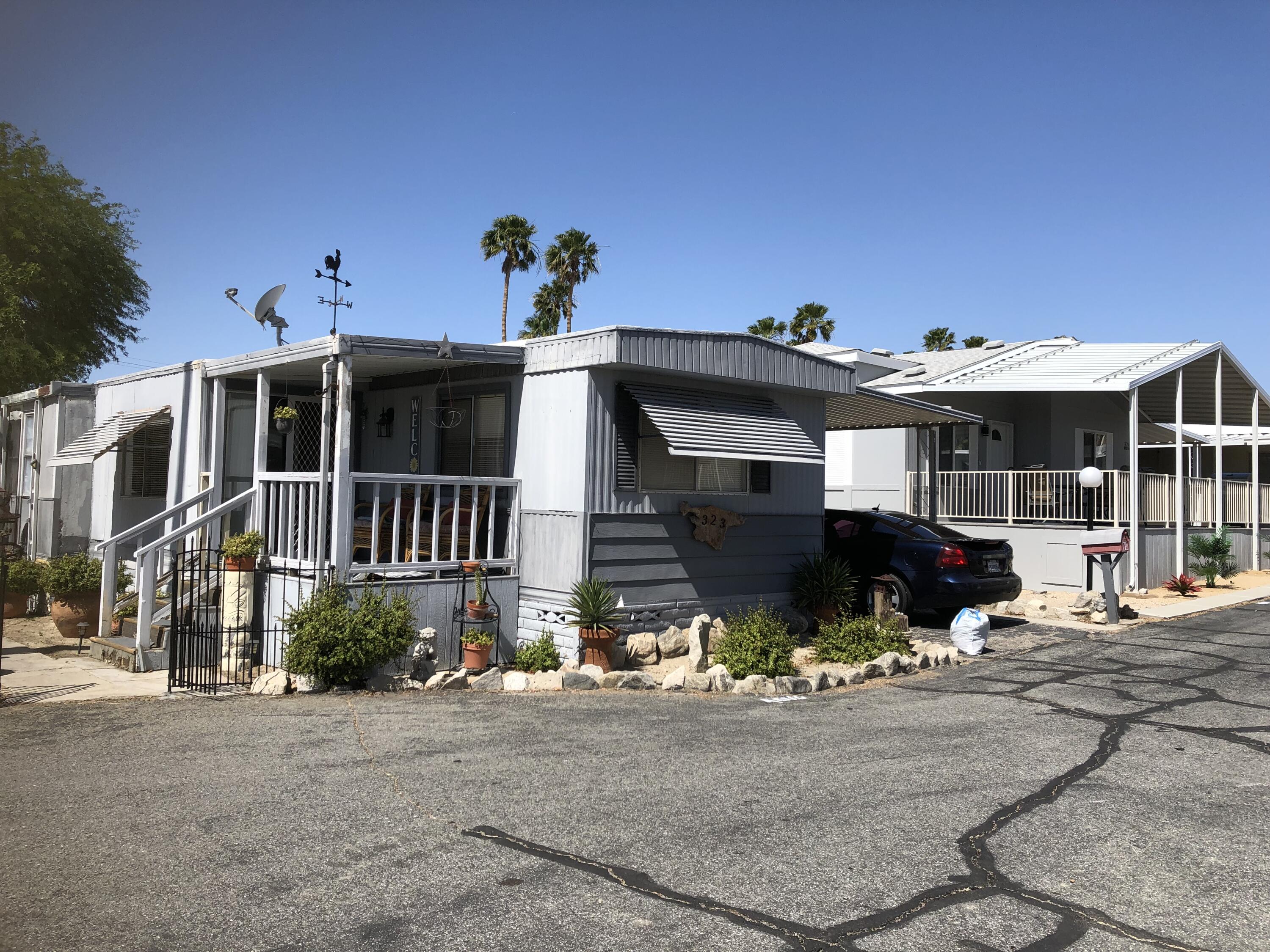 74711 Dillon Road Desert Hot Springs, CA 92241 - Photo 2 of 69 a front view of a house with a yard