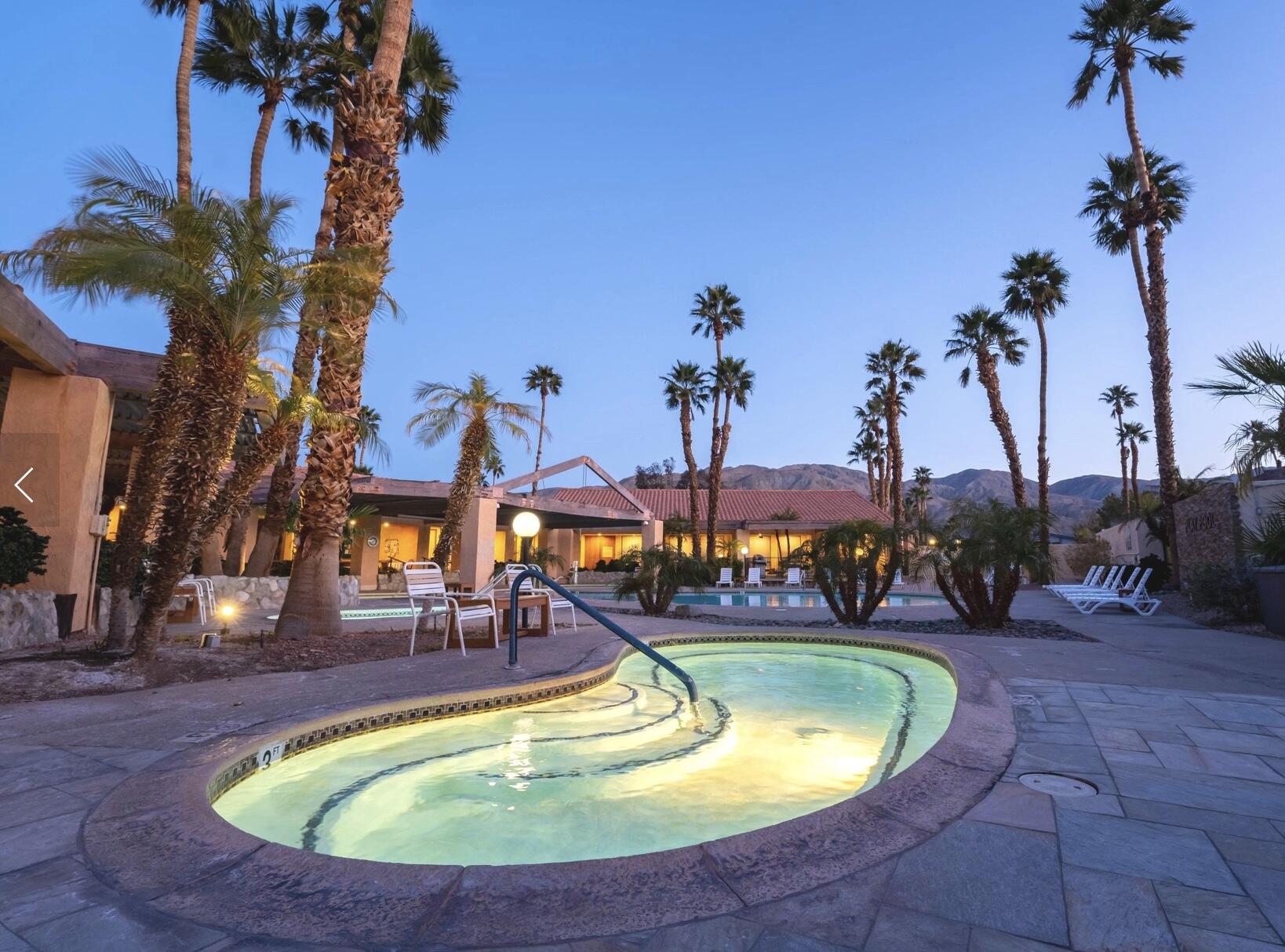 74711 Dillon Road Desert Hot Springs, CA 92241 - Photo 48 of 69 a view of a swimming pool with a table and chairs