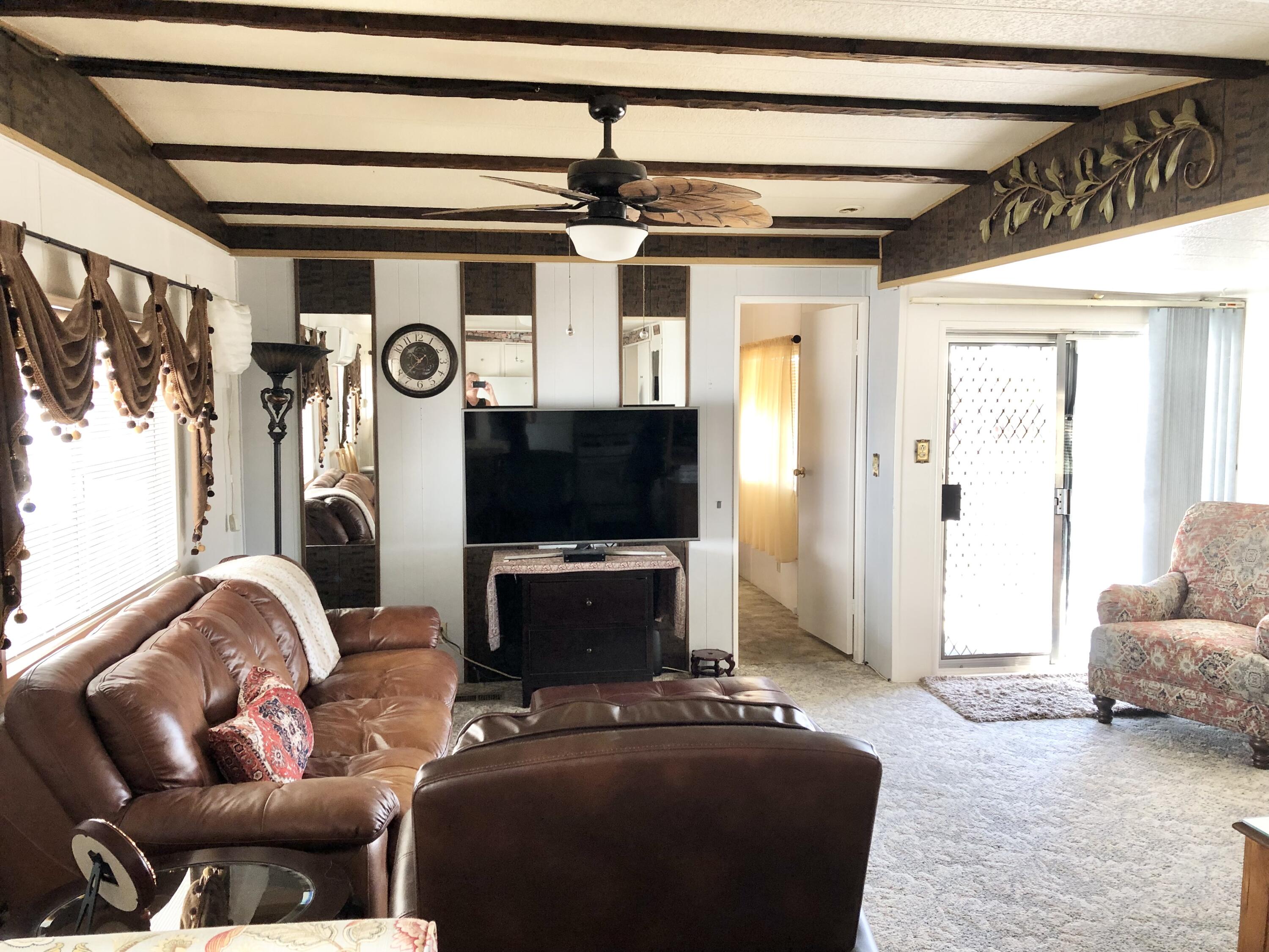 74711 Dillon Road Desert Hot Springs, CA 92241 - Photo 7 of 69 a living room with furniture and a flat screen tv
