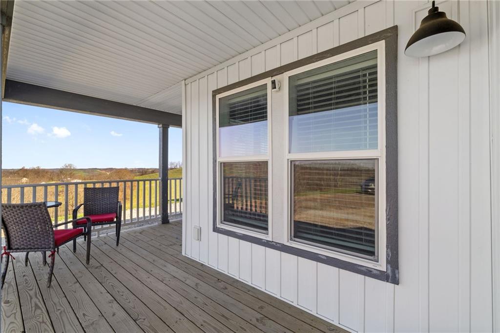 1350 Beham Ridge Road West Alexander, PA 15376 - Photo 30 of 48 a view of a balcony with chairs and wooden floor