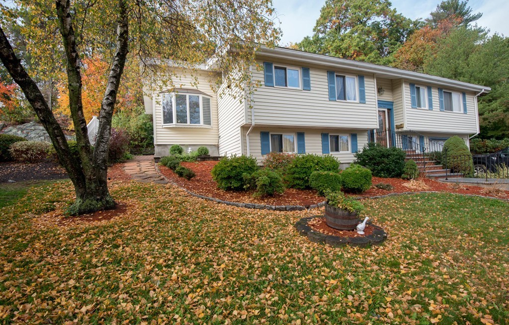 5 Fatima Road Stoneham, MA 02180 - Photo 1 of 20 a front view of a house with a yard and shrubs