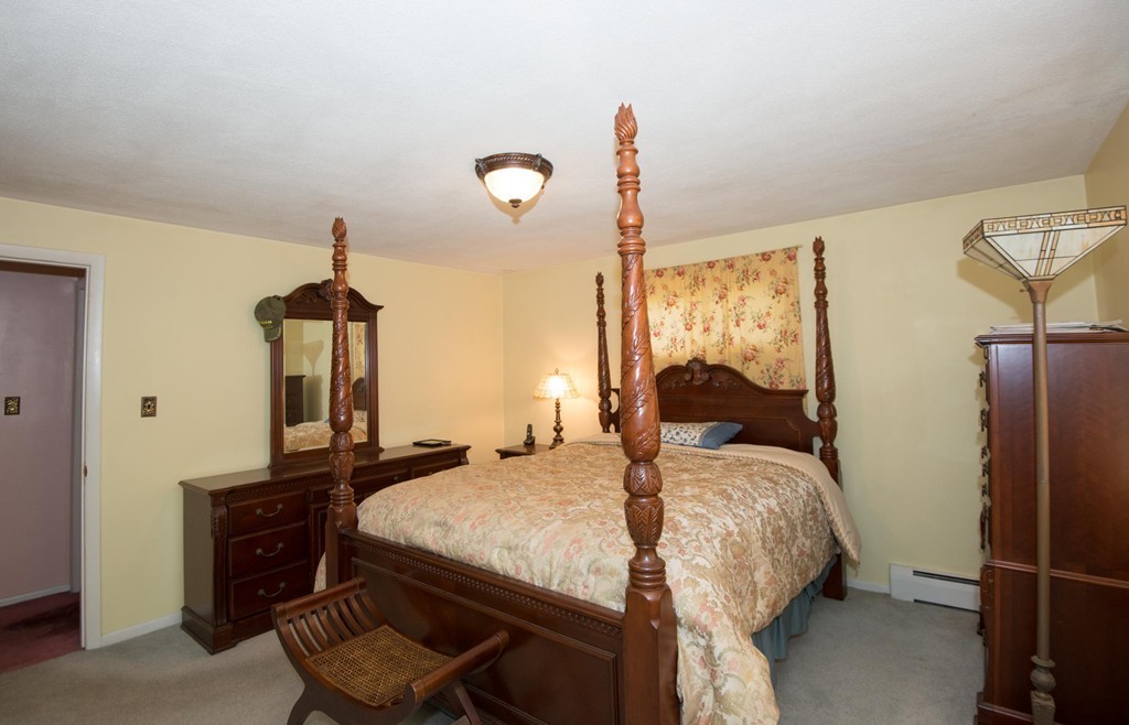 5 Fatima Road Stoneham, MA 02180 - Photo 11 of 20 a bedroom with a bed and wooden floor