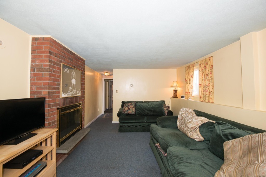 5 Fatima Road Stoneham, MA 02180 - Photo 14 of 20 a living room with furniture and a flat screen tv