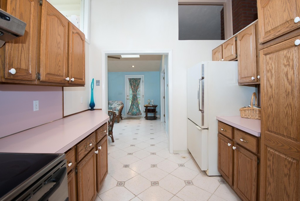 5 Fatima Road Stoneham, MA 02180 - Photo 8 of 20 a kitchen with a sink refrigerator and cabinets