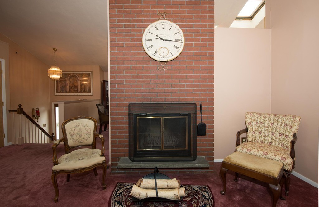 5 Fatima Road Stoneham, MA 02180 - Photo 10 of 20 a living room with furniture and a fireplace
