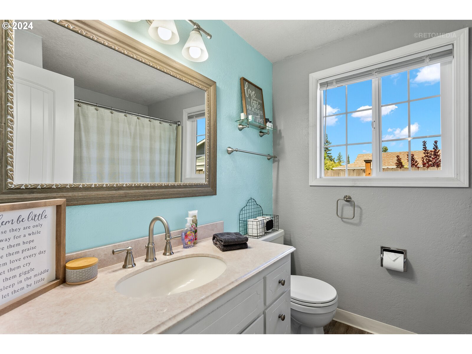 780 South Elm Court Canby, OR 97013 - Photo 23 of 32 a bathroom with a granite countertop sink mirror vanity and toilet