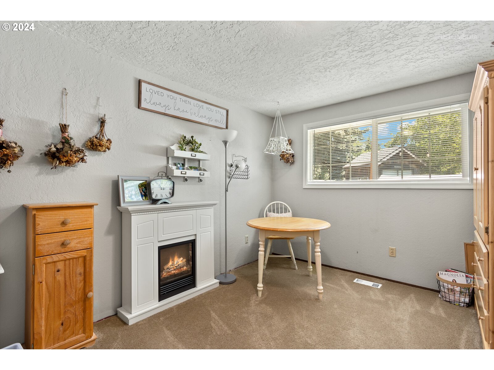780 South Elm Court Canby, OR 97013 - Photo 24 of 32 a living room with furniture a window and a fireplace