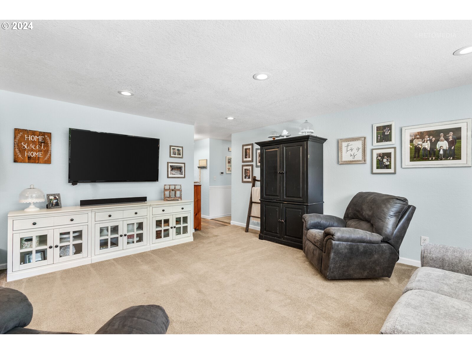 780 South Elm Court Canby, OR 97013 - Photo 9 of 32 a living room with furniture and a flat screen tv