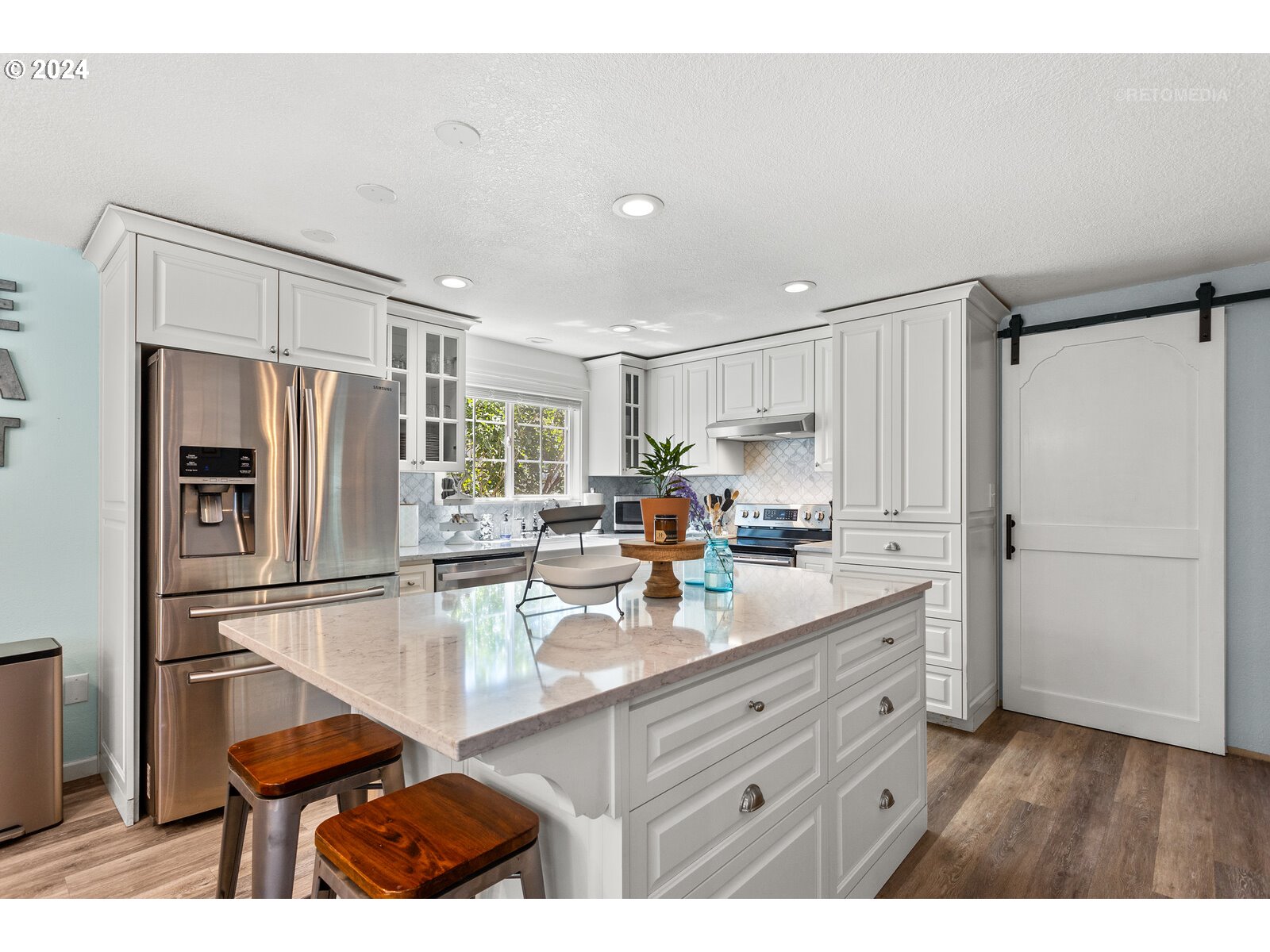 780 South Elm Court Canby, OR 97013 - Photo 10 of 32 a kitchen with refrigerator cabinets and wooden floor