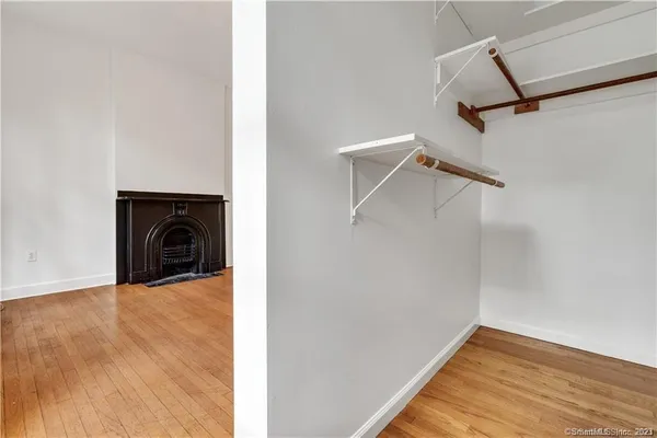 a view of a livingroom with wooden floor and a ceiling fan