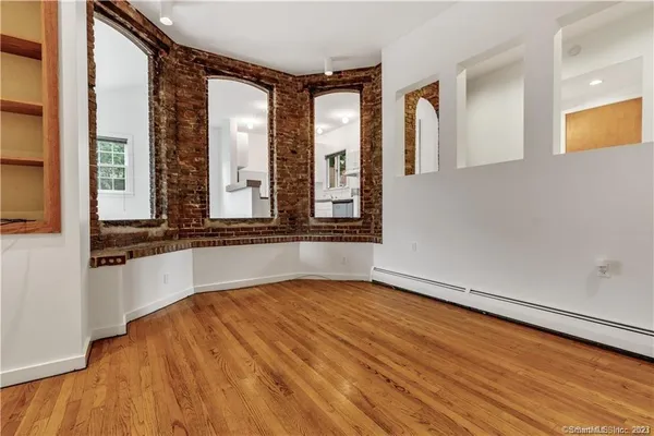 a view of an entryway with wooden floor and a window