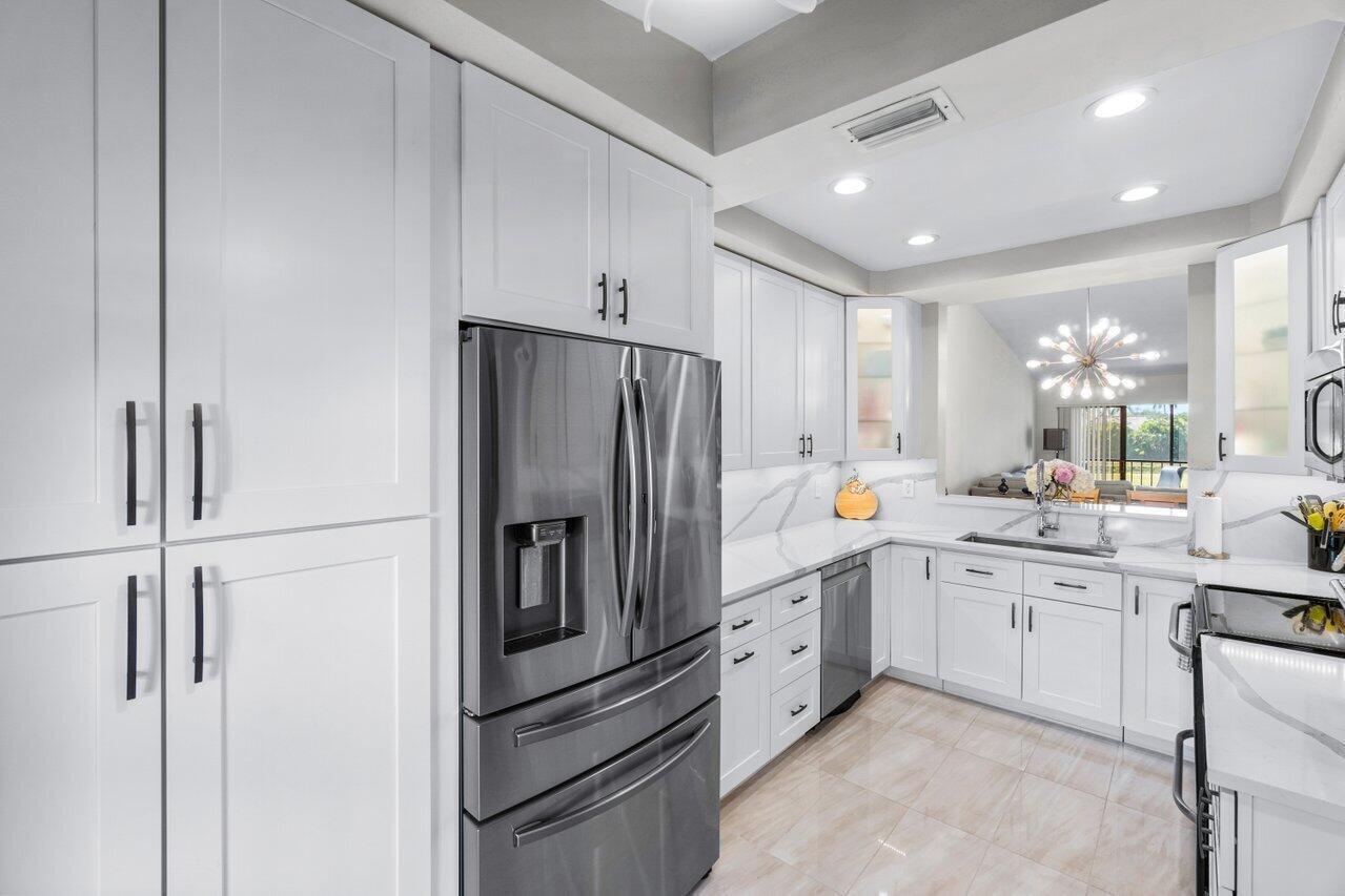 a kitchen with stainless steel appliances a refrigerator sink and cabinets
