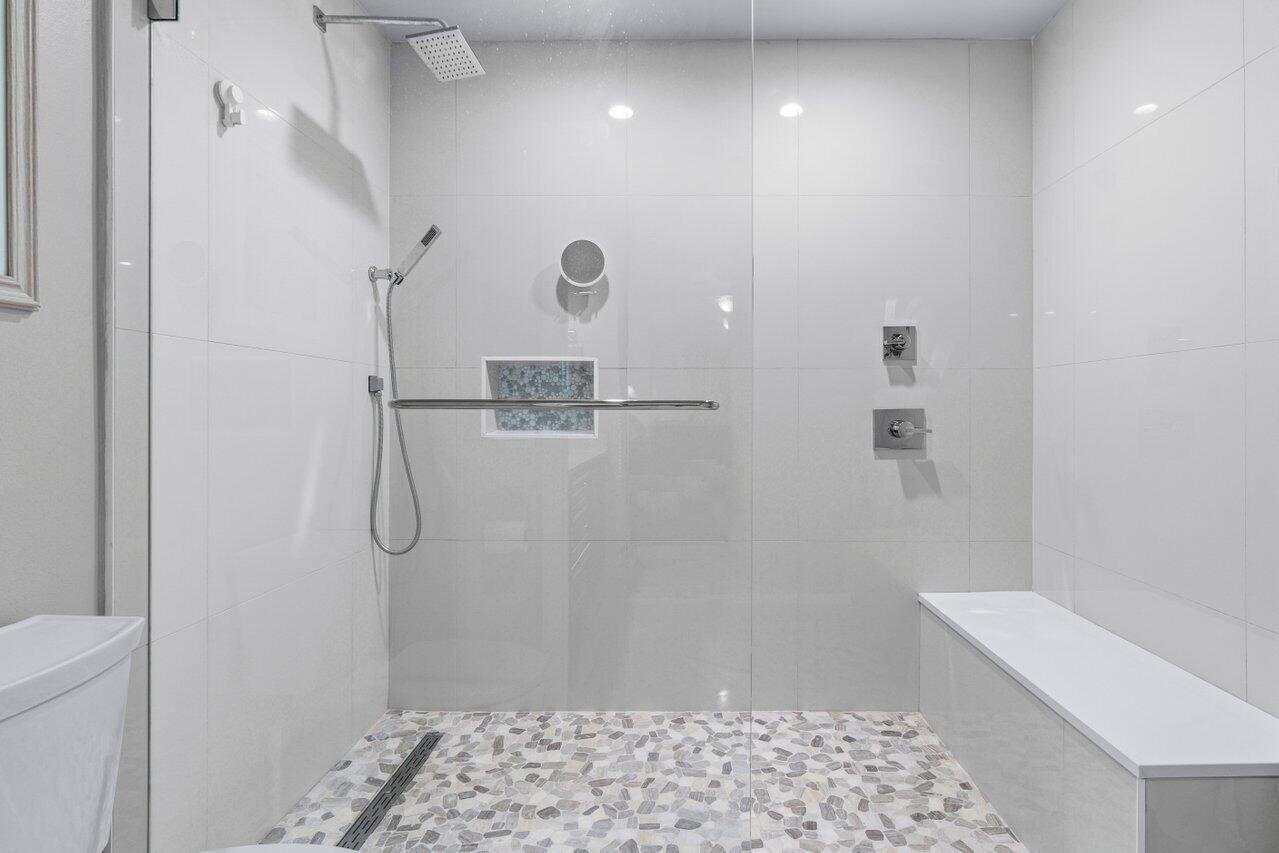 5120 Golfview Court, Unit 1722 Delray Beach, FL 33484 - Photo 14 of 46 a bathroom with a sink a toilet and shower