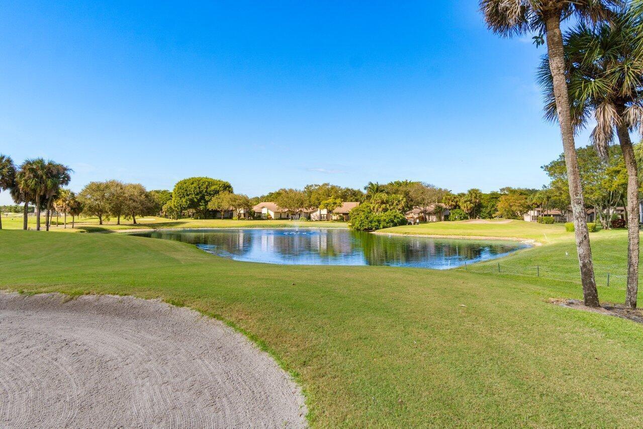 5120 Golfview Court, Unit 1722 Delray Beach, FL 33484 - Photo 22 of 46 a view of a lake with houses in the background