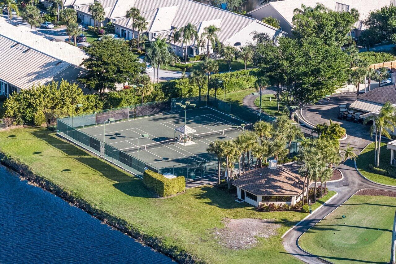 5120 Golfview Court, Unit 1722 Delray Beach, FL 33484 - Photo 33 of 46 a view of a swimming pool with a bench and some trees