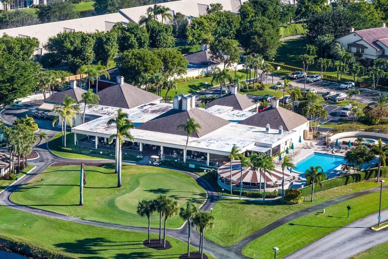 5120 Golfview Court, Unit 1722 Delray Beach, FL 33484 - Photo 35 of 46 an aerial view of a house with swimming pool and trees all around