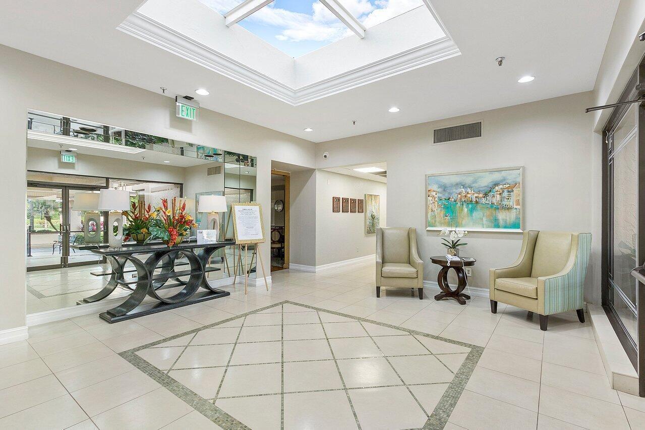 5120 Golfview Court, Unit 1722 Delray Beach, FL 33484 - Photo 40 of 46 a lobby with furniture and floor to ceiling window