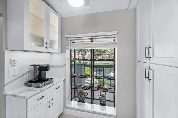 a kitchen with a stove and a white cabinet