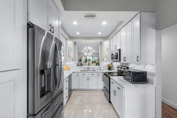 a kitchen with a refrigerator and a sink