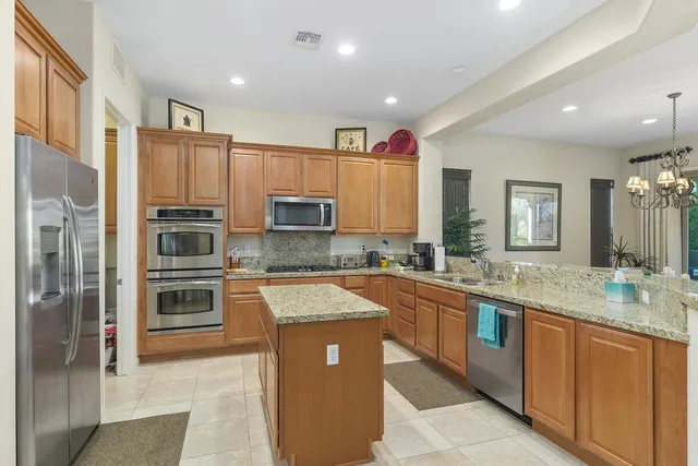 a bedroom with a bed and a lamp on dresser