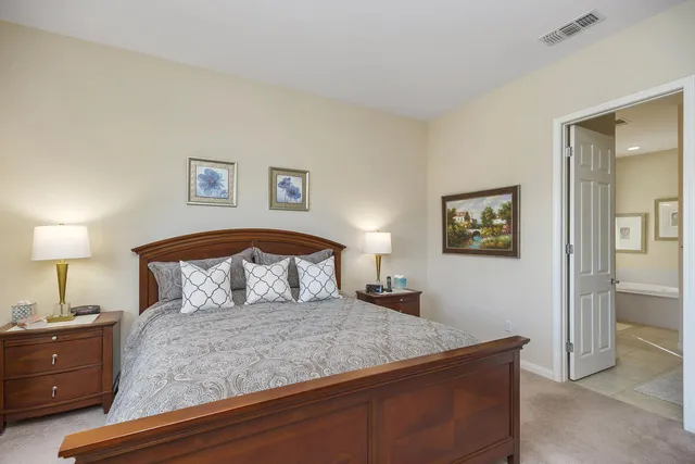 a bedroom with a bed and a lamp