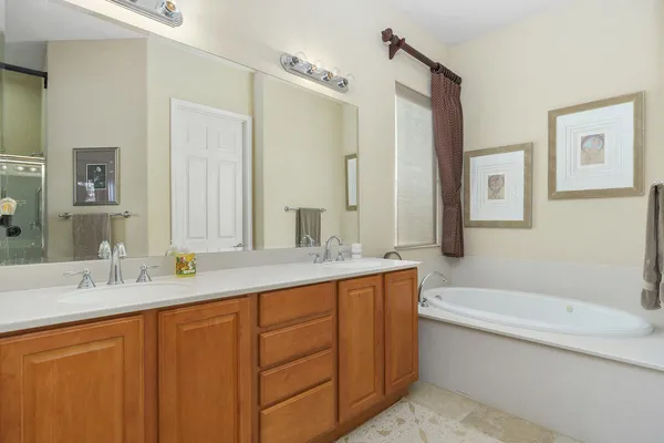 a bathroom with a sink a mirror a toilet and shower