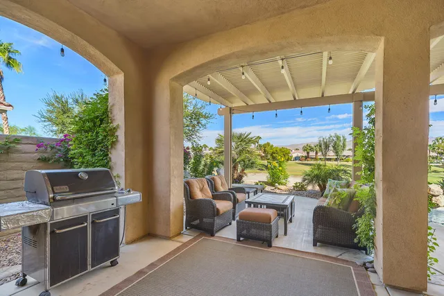 a view of a brick house with a large trees